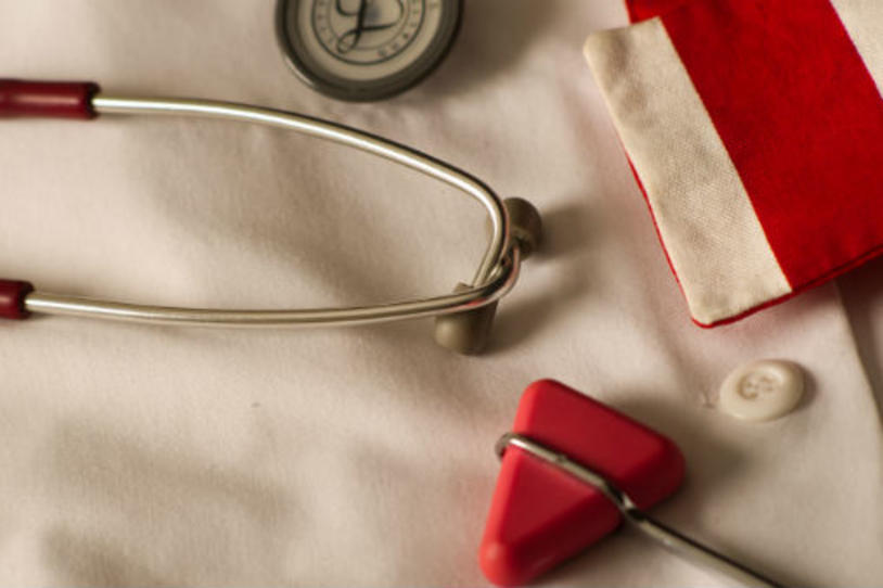 Doctor's white coat and red stethoscope.