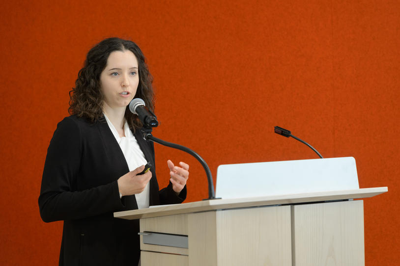 Dr. Marissa Dean speaking at a podium at the 2018 Edmond J. Safra "Fellowship Symposium Day."