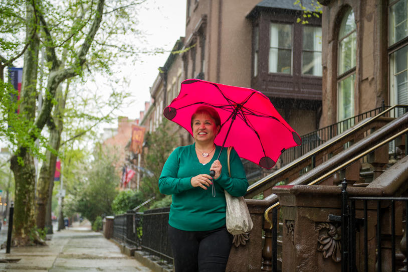 Woman walking outside holding an umbrella