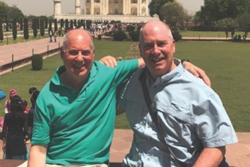 PPMI Participant Hyam Kramer and his husband Tom posing in front of the Taj Mahal on their vacation.