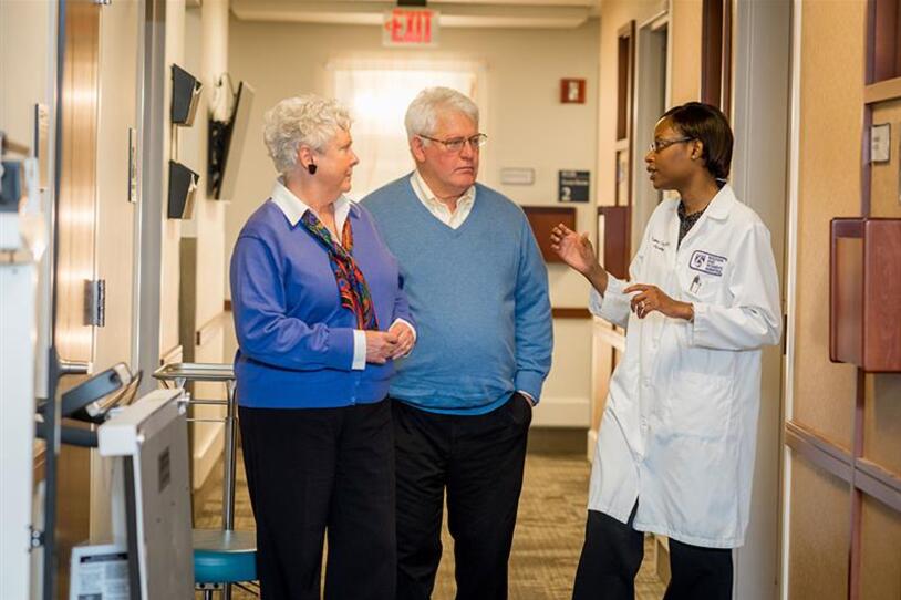 Parkinson's patient and care partner meet with doctor