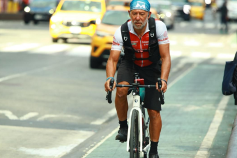 Alejandro Carcano biking on the streets of New York City. 