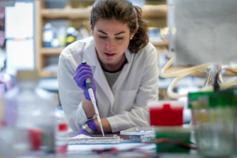 Female researcher pipetting in the lab.