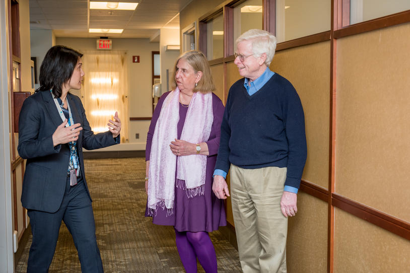 Three people talking at a clinic