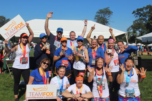 Group shot of Team Fox members holding Team Fox signs and cheering.