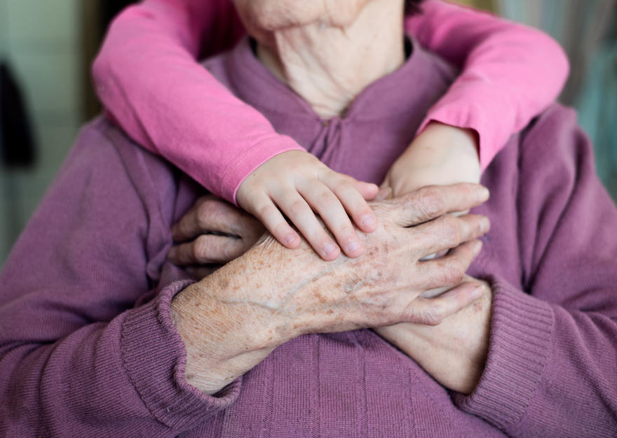 Child embracing grandparent.