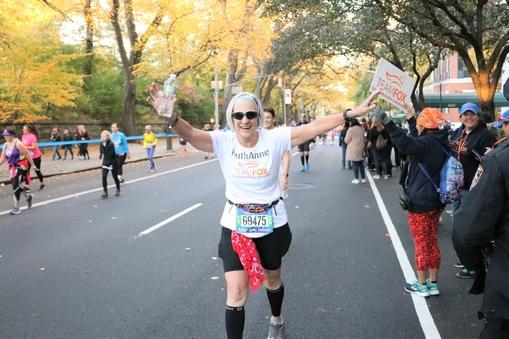 Marathoner cheering while running.