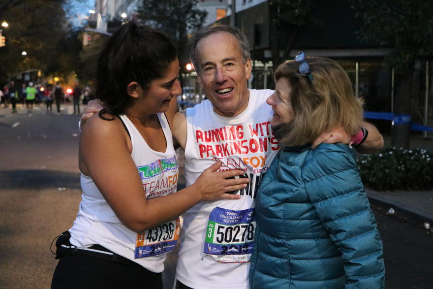 Marathon finisher with family smiling