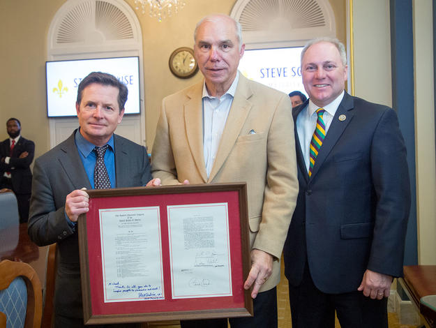 Michael J. Fox, Patient Council member Quentin Dastugue and Steve Scalise with the signed 21st Century Cures Act.