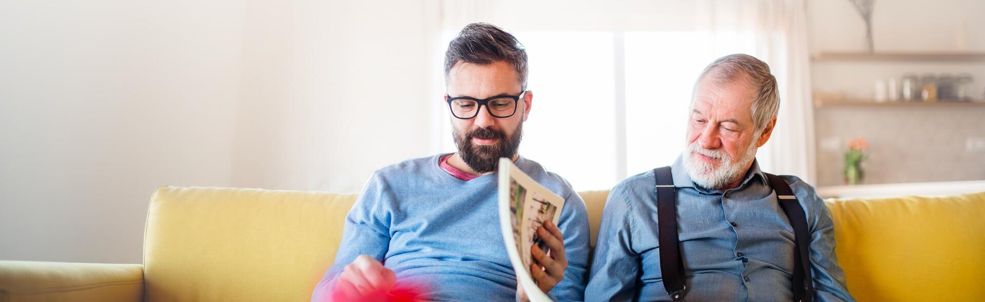 two men sitting on a couch