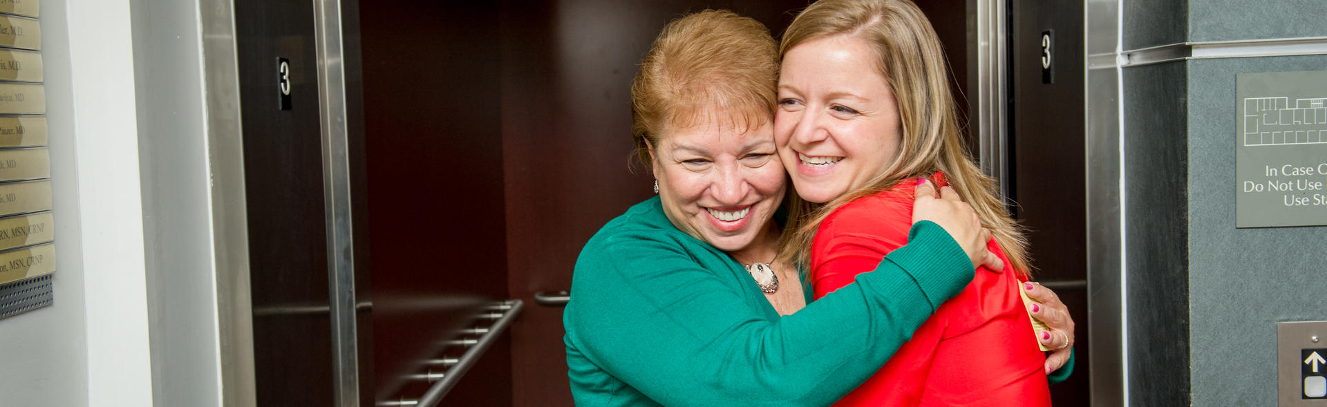 Two women hugging happily