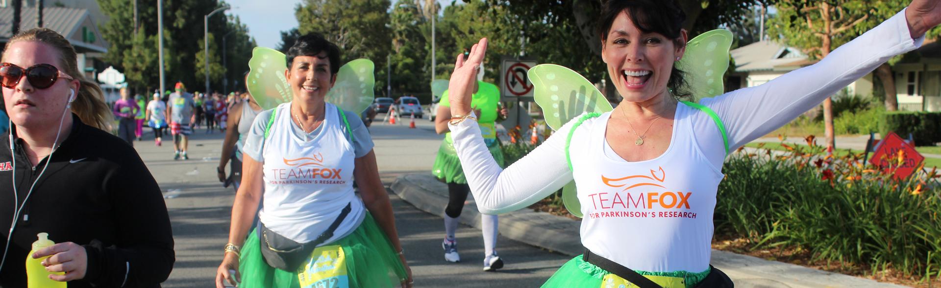 Two females in fairy costumes at a Team Fox event.