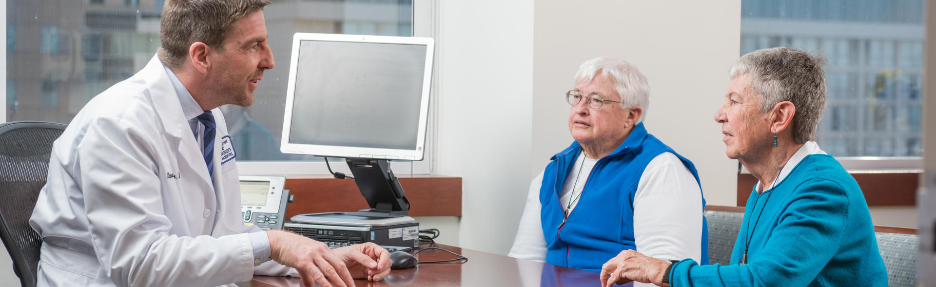 Doctor speaking to two people