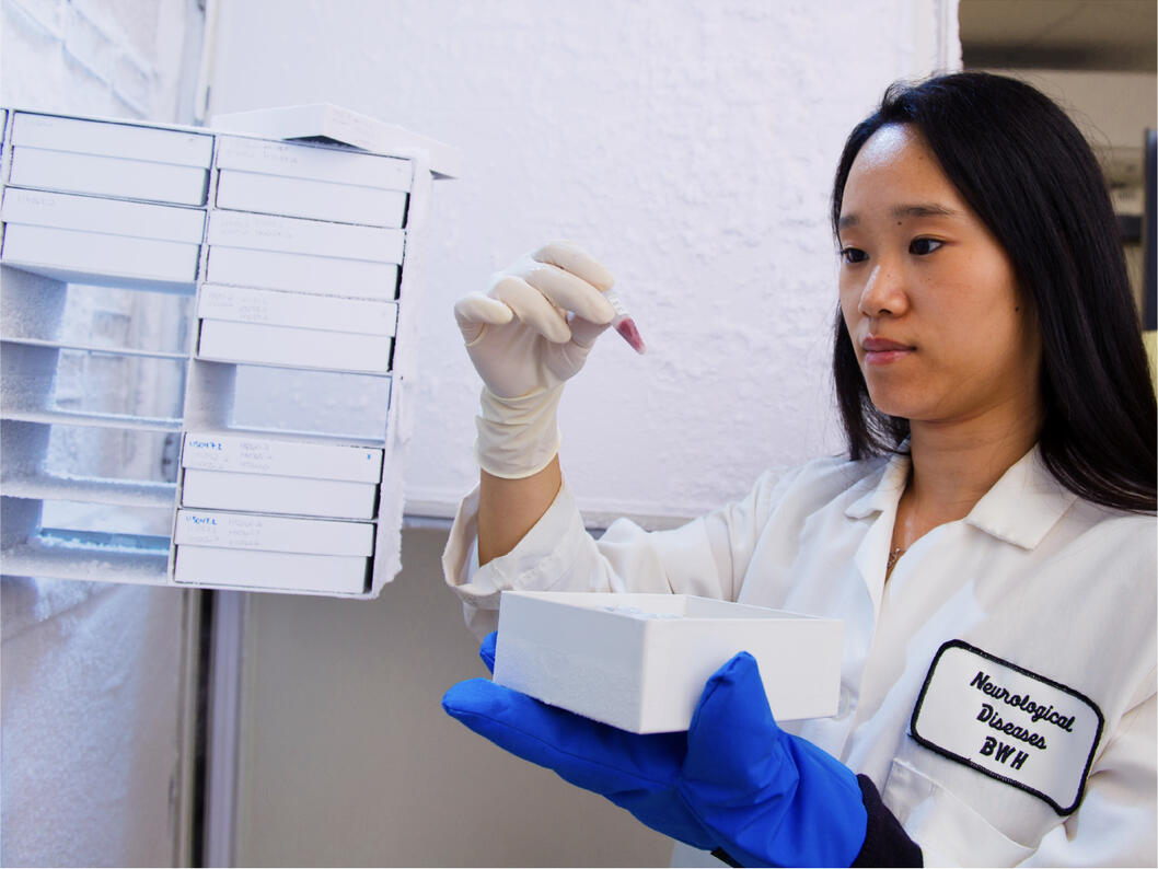 A female scientist looking at a sample in a laboratory