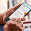 Close-up image of person holding phone and using Fox Trial Finder.