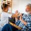 Grandfather and granddaughter laughing together