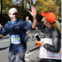 Gary gets a high five from Susie as he passes the Team Fox cheer zone at the 2018 New York City Marathon.
