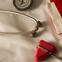 Doctor's white coat and red stethoscope.