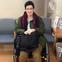 Woman sitting in wheelchair at doctor's office
