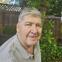 A photograph of Jim O'Connell smiling in a backyard.
