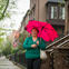 Woman walking outside holding an umbrella