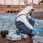 Person tests water for chemical contamination.