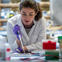 Female researcher in lab with pipette.