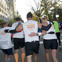 Team Fox marathon runners embracing on course.