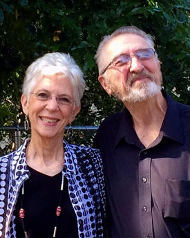 Middle aged male and female couple smiling for camera.
