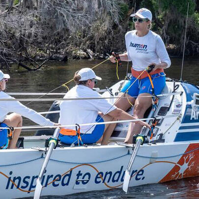 Woman stands on a team rowboat
